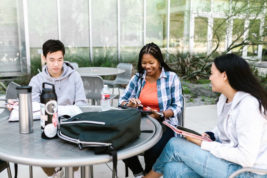 Students working together outside a campus residence